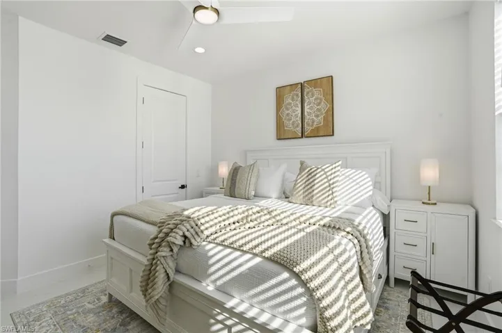 Bedroom with a ceiling fan and recessed lighting