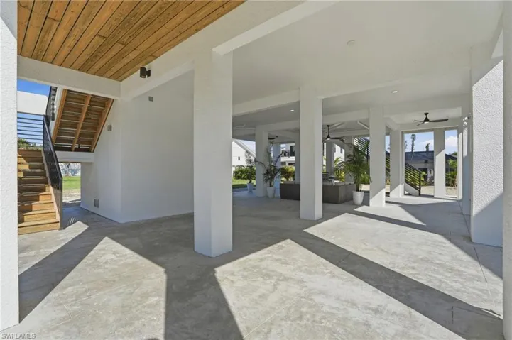 View of patio / terrace with stairs, a ceiling fan, and an outdoor living space