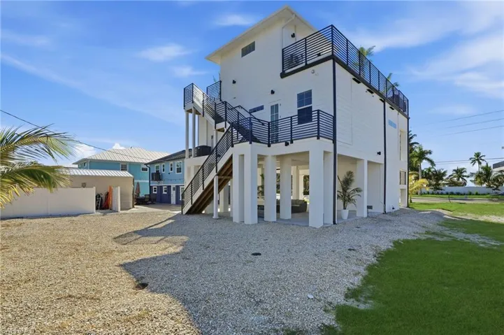 Back of house with a patio area and stairs