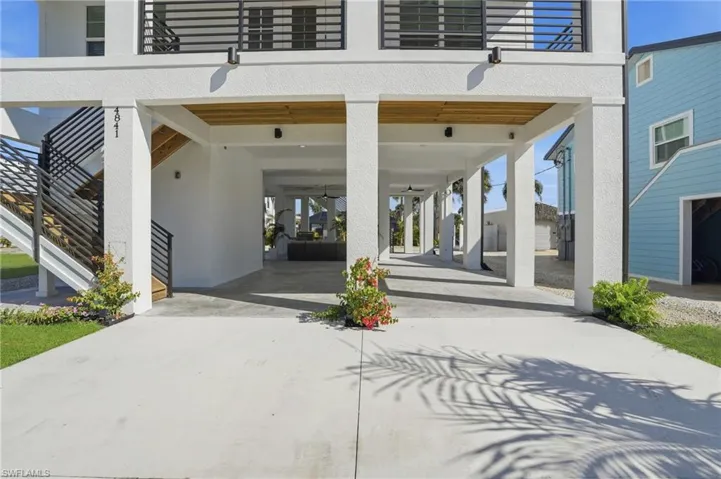 Entrance to property with a carport and concrete driveway