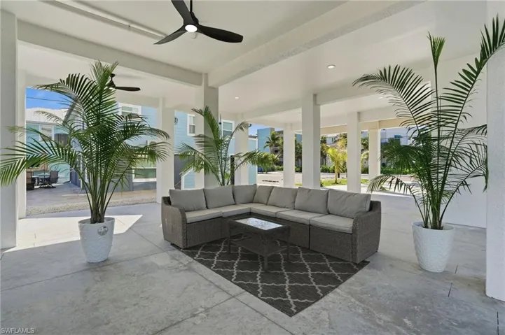 View of patio featuring an outdoor living space and ceiling fan