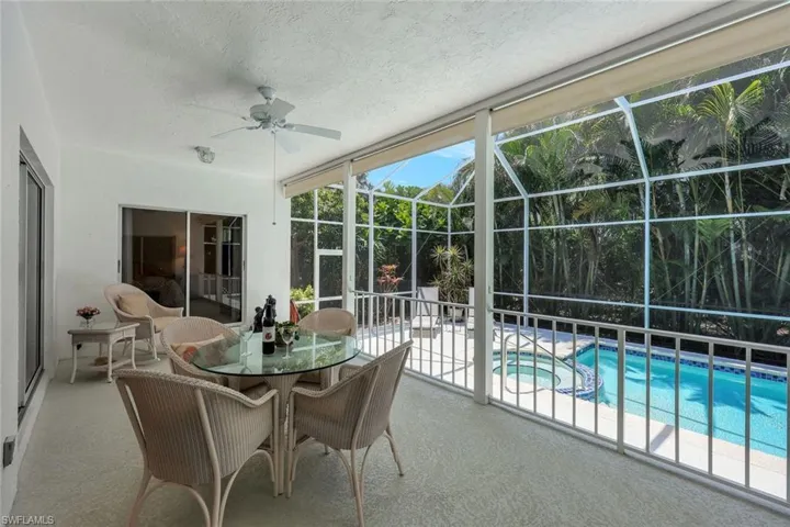 Sunroom with a ceiling fan and a jacuzzi