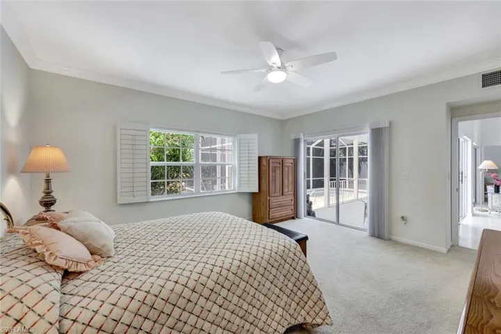 Bedroom featuring crown molding, carpet floors, access to outside, and multiple windows
