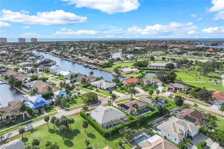 Birds eye view of property with a water view