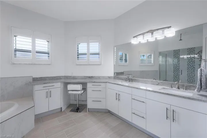 MAster Bathroom with shower with separate bathtub and vanity