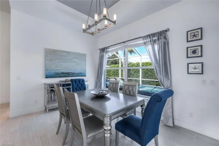 Dining space featuring crown molding, a tray ceiling, and an inviting chandelier