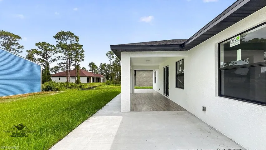 Spacious covered patio with wood-finish flooring, recessed lighting, and direct access to the interior