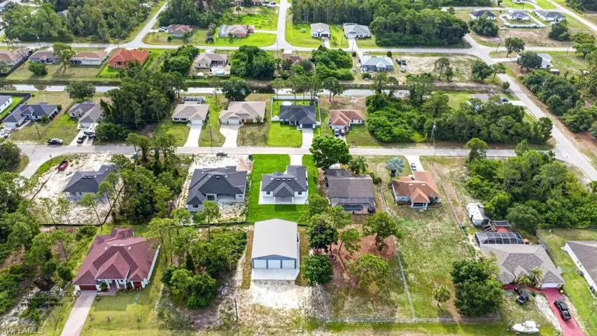 Residential development featuring a variety of single-story and two-story homes with individual driveways and green spaces