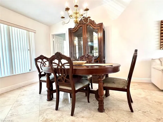 Dining room featuring lofted ceiling and a chandelier