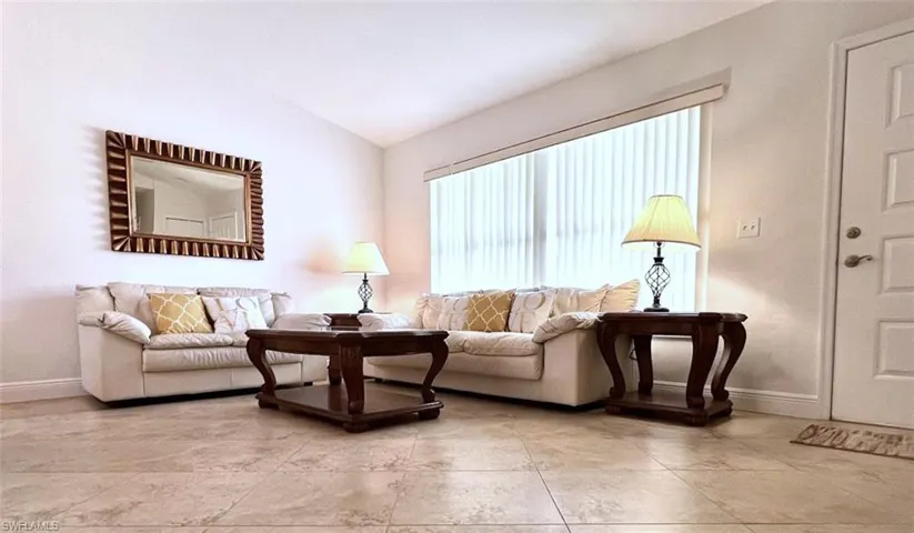 Living room with vaulted ceiling with lots of natural light