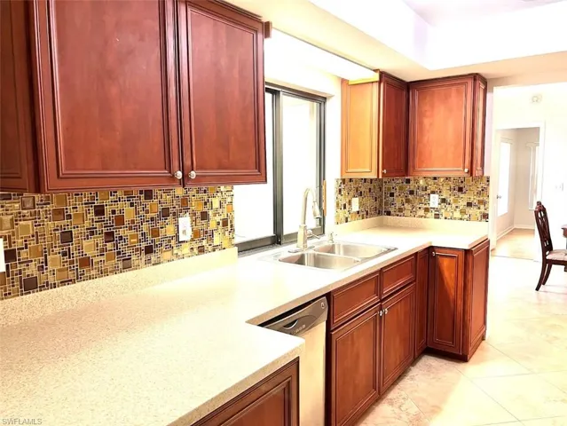 Kitchen with Corian counter tops and  pass thru to enclosed lanai
