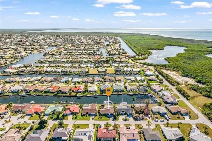 Aerial perspective of suburban area featuring a large body of water