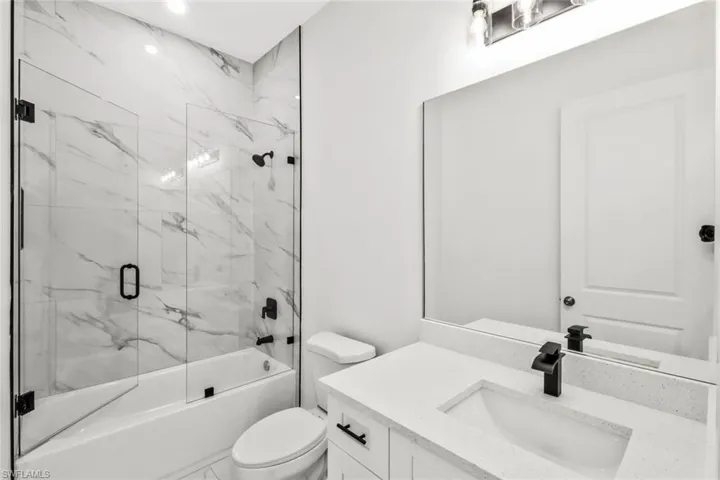 Full bathroom featuring vanity and combined bath / shower with glass door