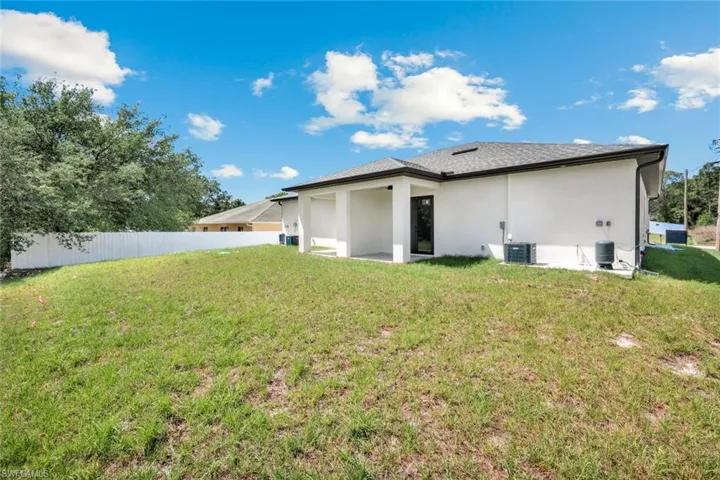 Back of house with stucco siding and a patio area