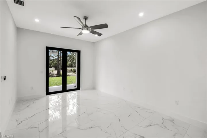 Spare room featuring recessed lighting, ceiling fan, french doors, and light marble finish flooring