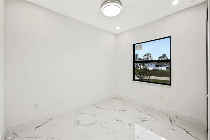 Unfurnished room with recessed lighting and light marble finish floors