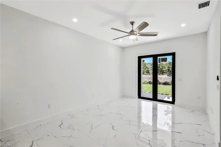 Unfurnished room featuring french doors, recessed lighting, light marble finish flooring, and ceiling fan