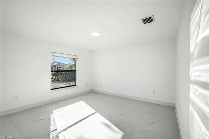 Dedicated bright living room with tile floors and recessed lighting.