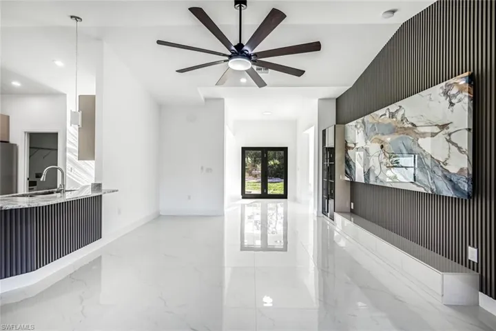Open-concept living area showcasing clean lines, bright finishes, and a great flow toward the kitchen—ideal for entertaining.