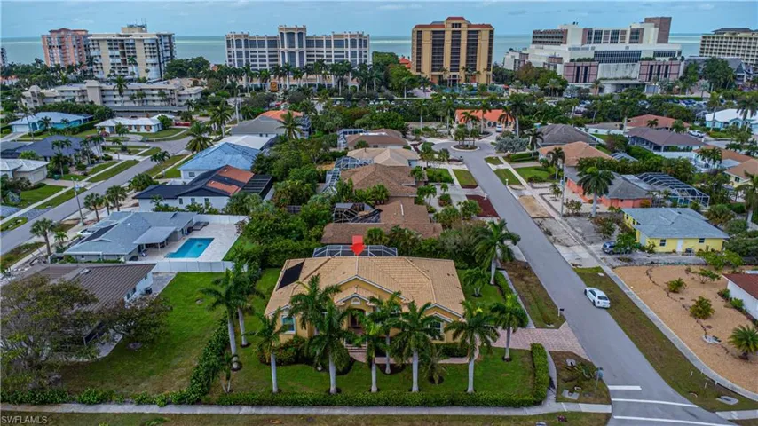 Birds eye view of property with a water view