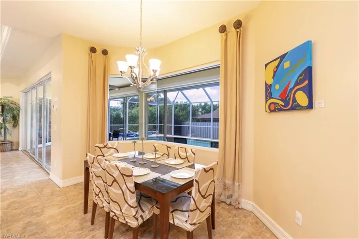 Dining area featuring tile patterned flooring and an inviting chandelier