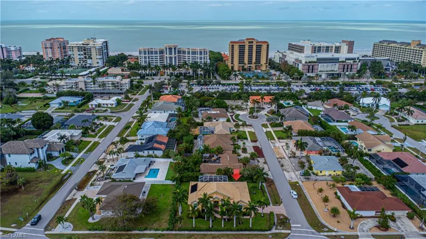 Birds eye view of property with a water view