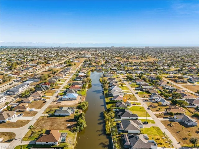 Aerial overview of property's location featuring nearby suburban area and a large body of water