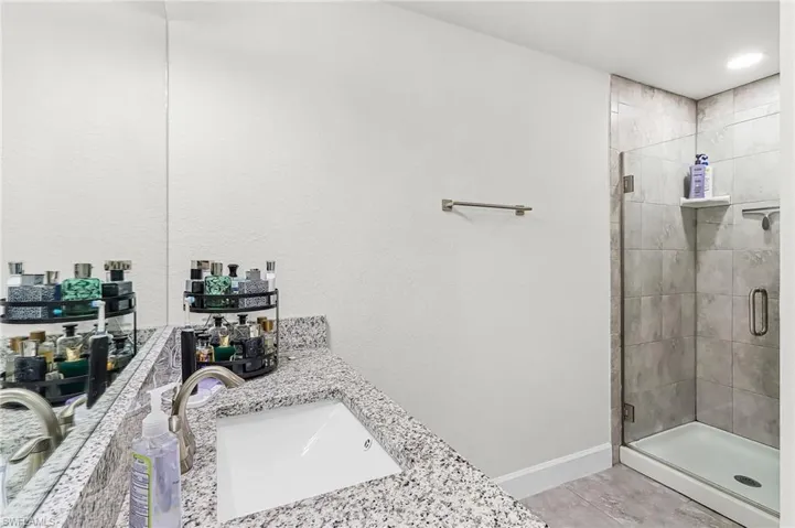 Bathroom featuring vanity and a shower stall