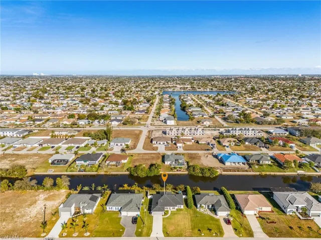Aerial perspective of suburban area featuring a nearby body of water