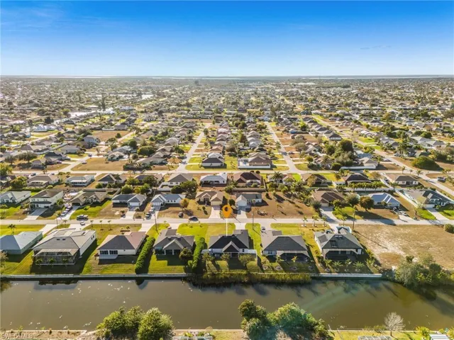 Aerial view of property's location featuring nearby suburban area