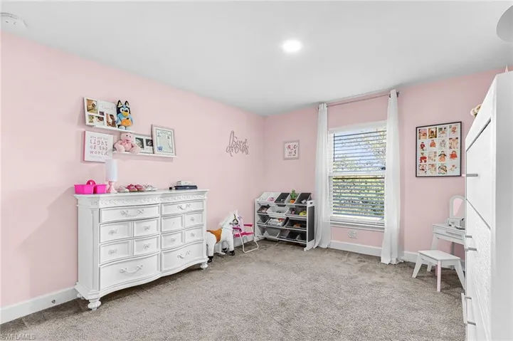 Game room with baseboards and light carpet