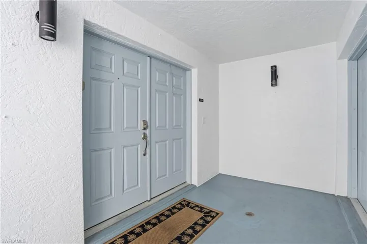 Property entrance with stucco siding - Virtually Edited Image