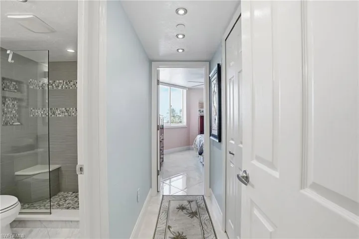 Ensuite bathroom featuring a shower stall and recessed lighting - Virtually Edited Image