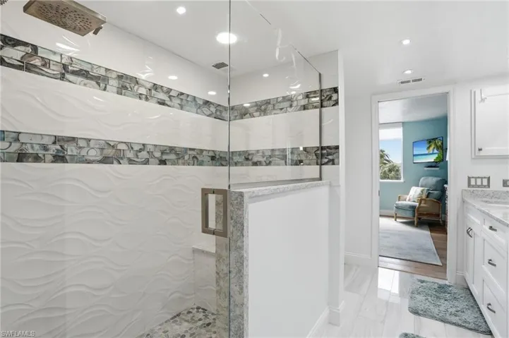 Ensuite bathroom with vanity, a stall shower, and recessed lighting - Virtually Edited Image