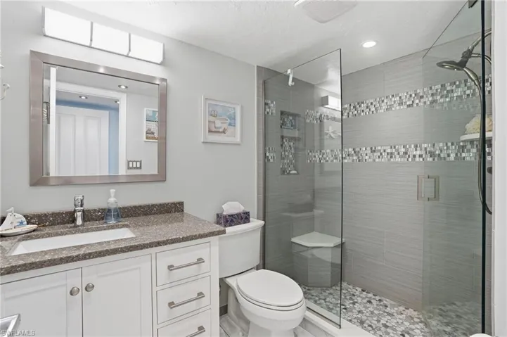 Bathroom with vanity and a shower stall - Virtually Edited Image
