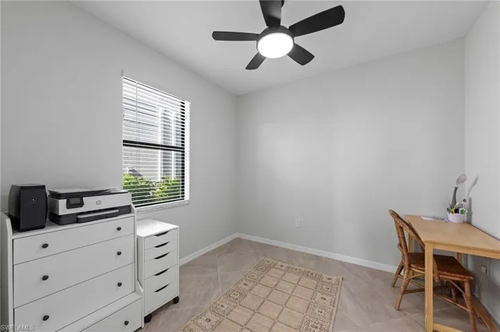 Neutral wall color, ceiling fan with integrated lighting, tiled flooring, and window with horizontal blinds