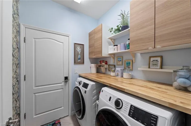 Wood-finish cabinetry, light wood-finish countertop, and open shelving