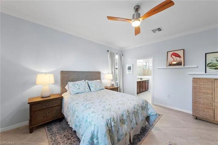 Crown molding, tile flooring, and a ceiling fan with light fixture