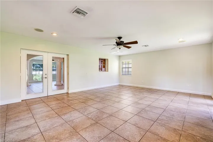 Empty room featuring french doors, recessed lighting, light tile patterned flooring, and a ceiling fan