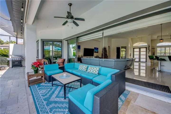 View of patio / terrace featuring ceiling fan, a sunroom, a grill, and outdoor lounge area
