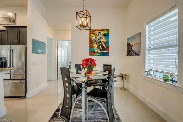 Dining area with plenty of natural light, a chandelier, and light tile patterned floors
