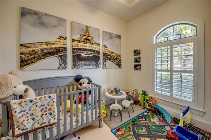 Bedroom featuring a crib