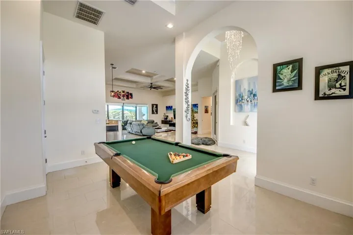 Game room featuring billiards, coffered ceiling, ceiling fan, recessed lighting, and a chandelier