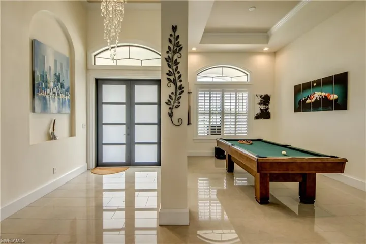 Game room featuring french doors, billiards table, ornamental molding, a chandelier, and recessed lighting