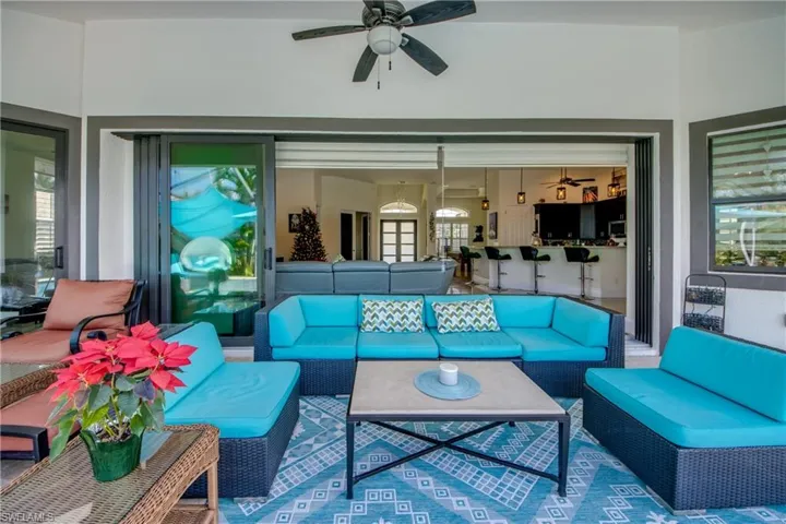 View of patio with an outdoor hangout area and ceiling fan