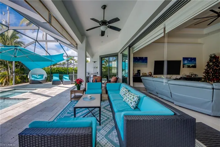 View of patio / terrace with a ceiling fan, a lanai, a sunroom, and an outdoor living space