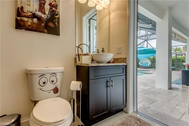 Half bathroom featuring vanity and toilet