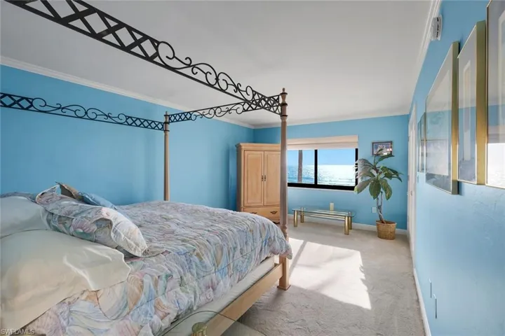 Bedroom featuring light carpet and ornamental molding