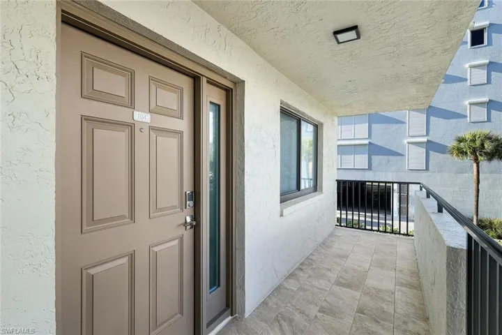 Property entrance featuring stucco siding