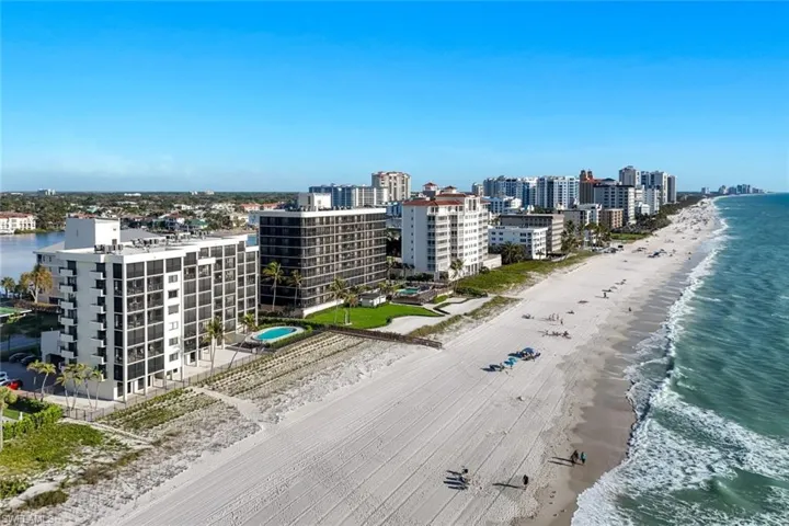 View of urban area featuring waterfront with a beach
